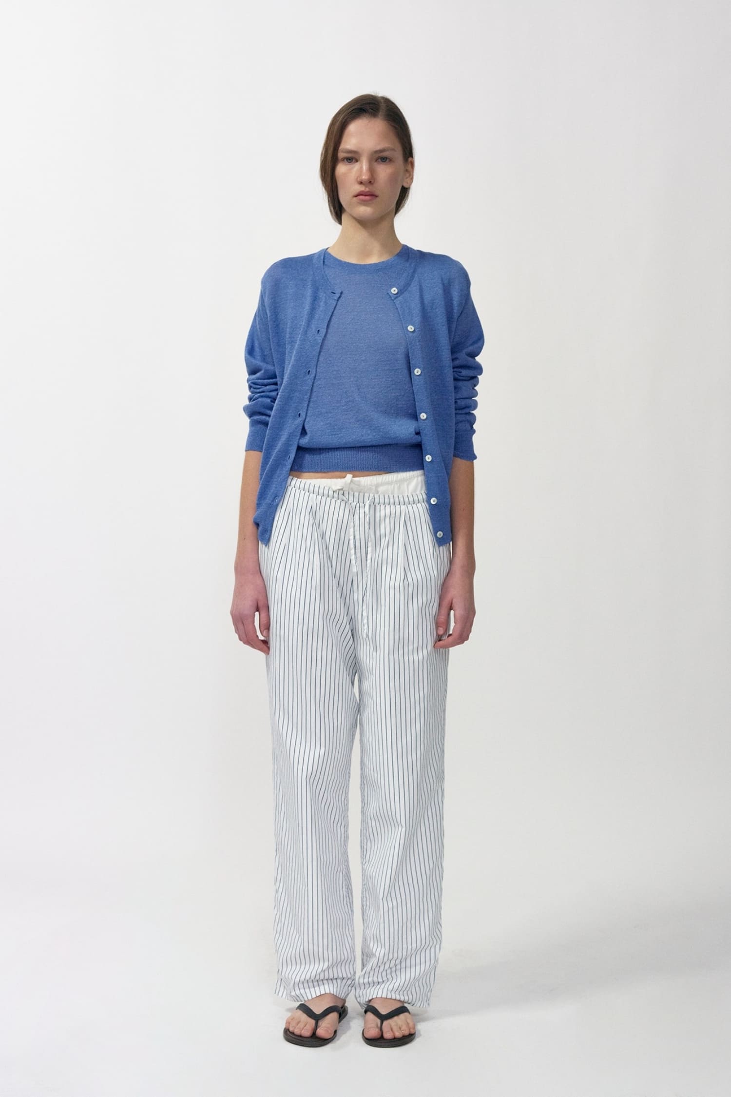 Nothing Written navy stripe cotton pants worn front view with elastic waistband and relaxed straight leg fit | hover