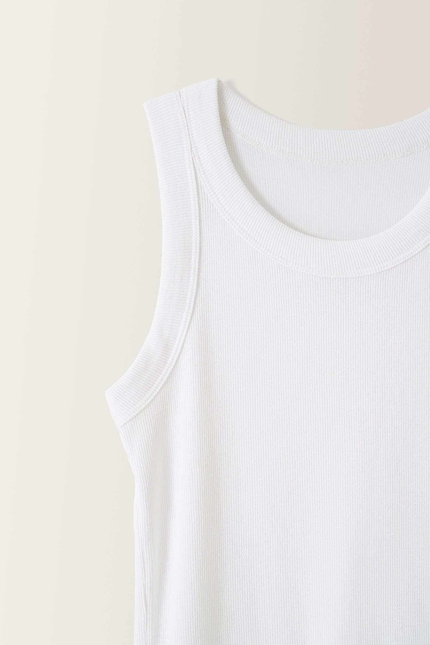 Detail of neckline on Nothing Written white ribbed cotton tank top