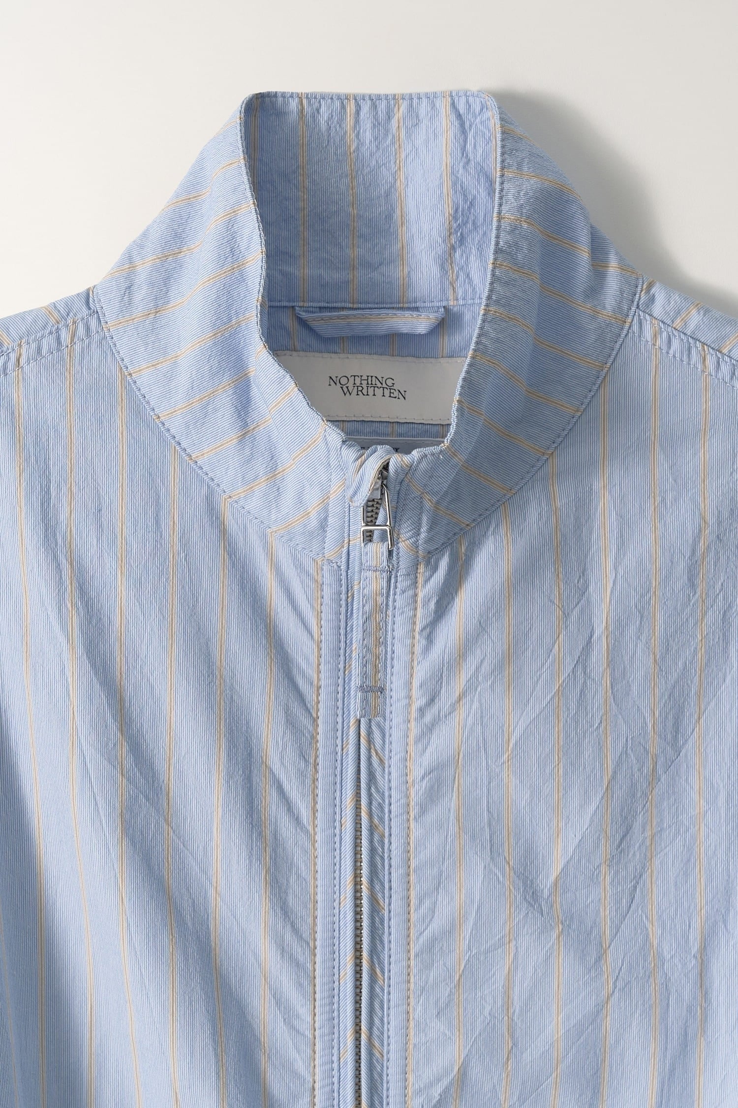 Detail of collar and zipper on Nothing Written Blue Stripe Zip Jacket