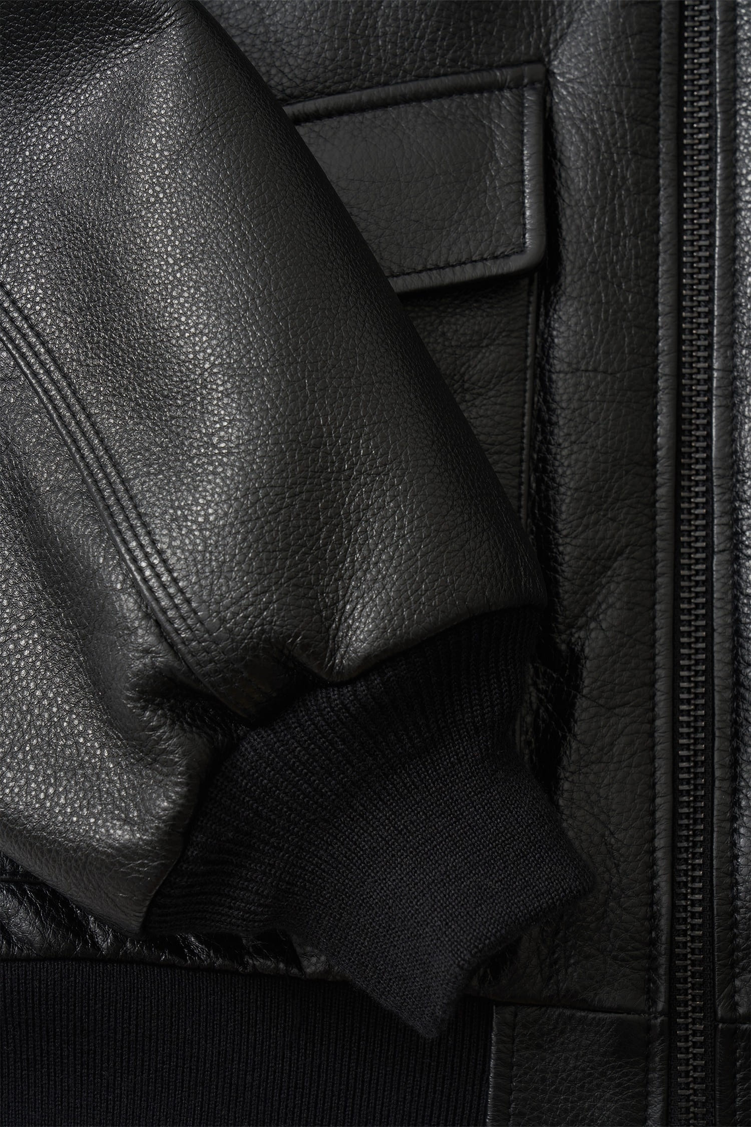 Detail of textured black leather and ribbed cuff on Nothing Written bomber jacket