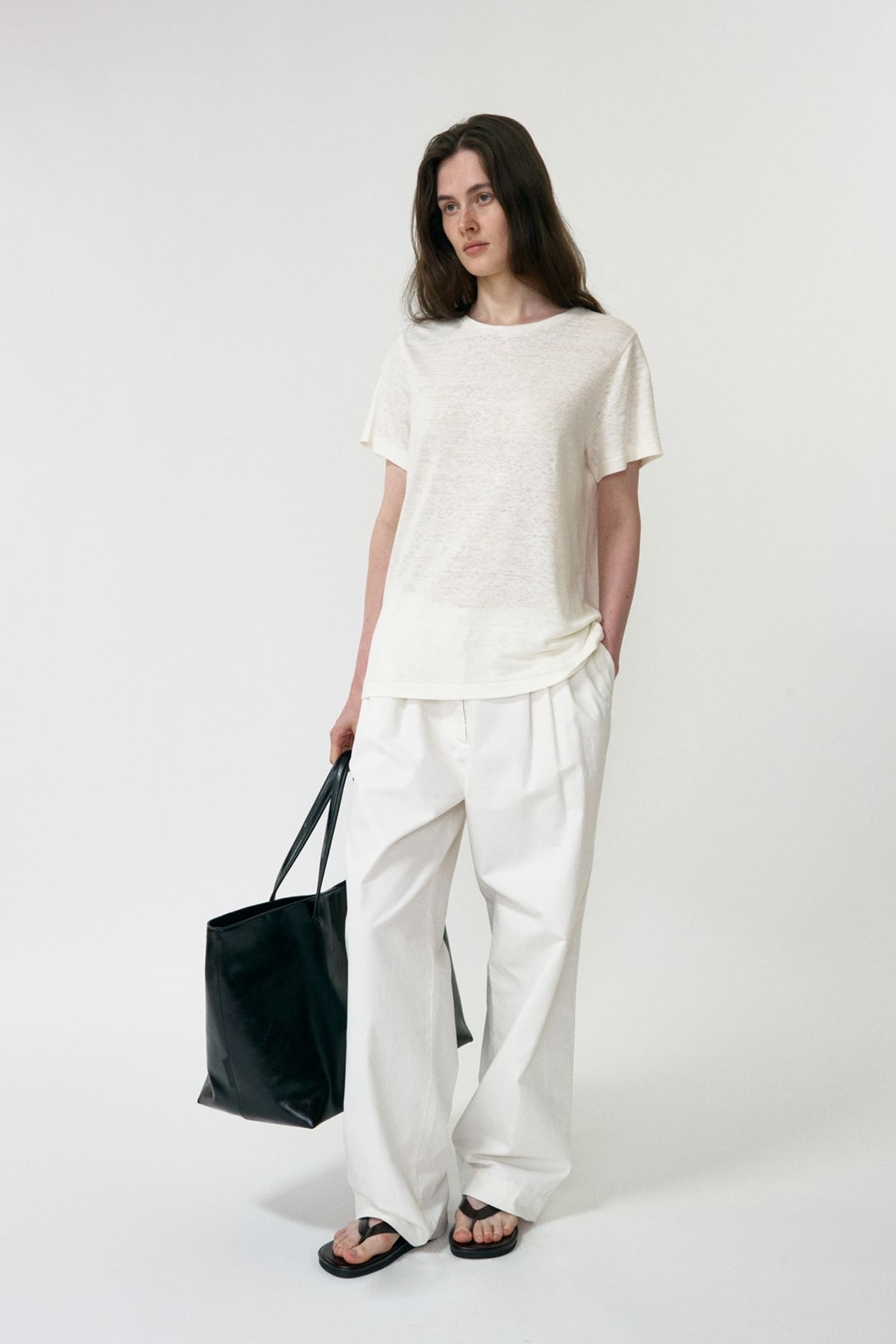  Nothing Written white tuck pants relaxed fit worn angled view| hover