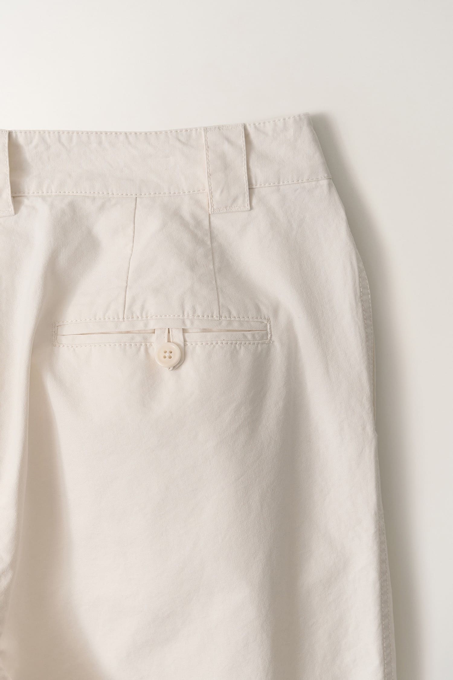 Detail of back pocket on Nothing Written Lena Tuck pants white