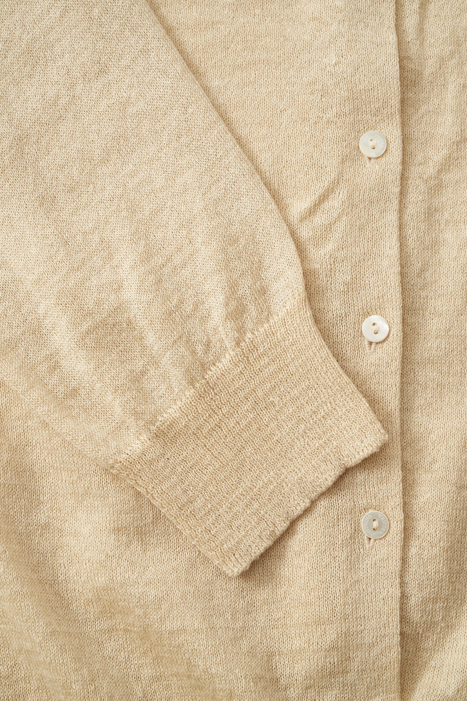 Close-up of linen knit texture on Nothing Written yellow cardigan