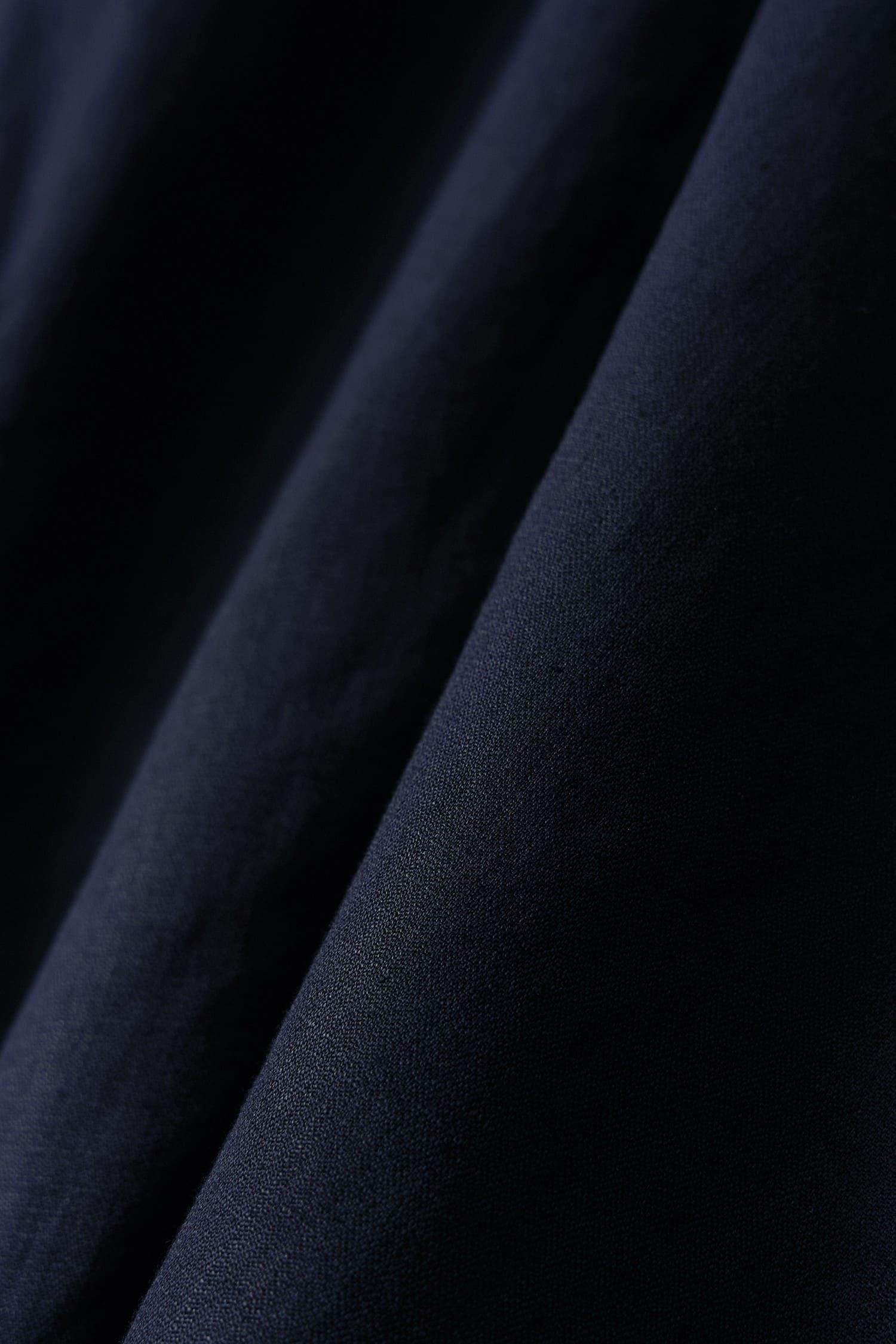 Close-up of navy linen fabric texture on Nothing Written oversized jacket