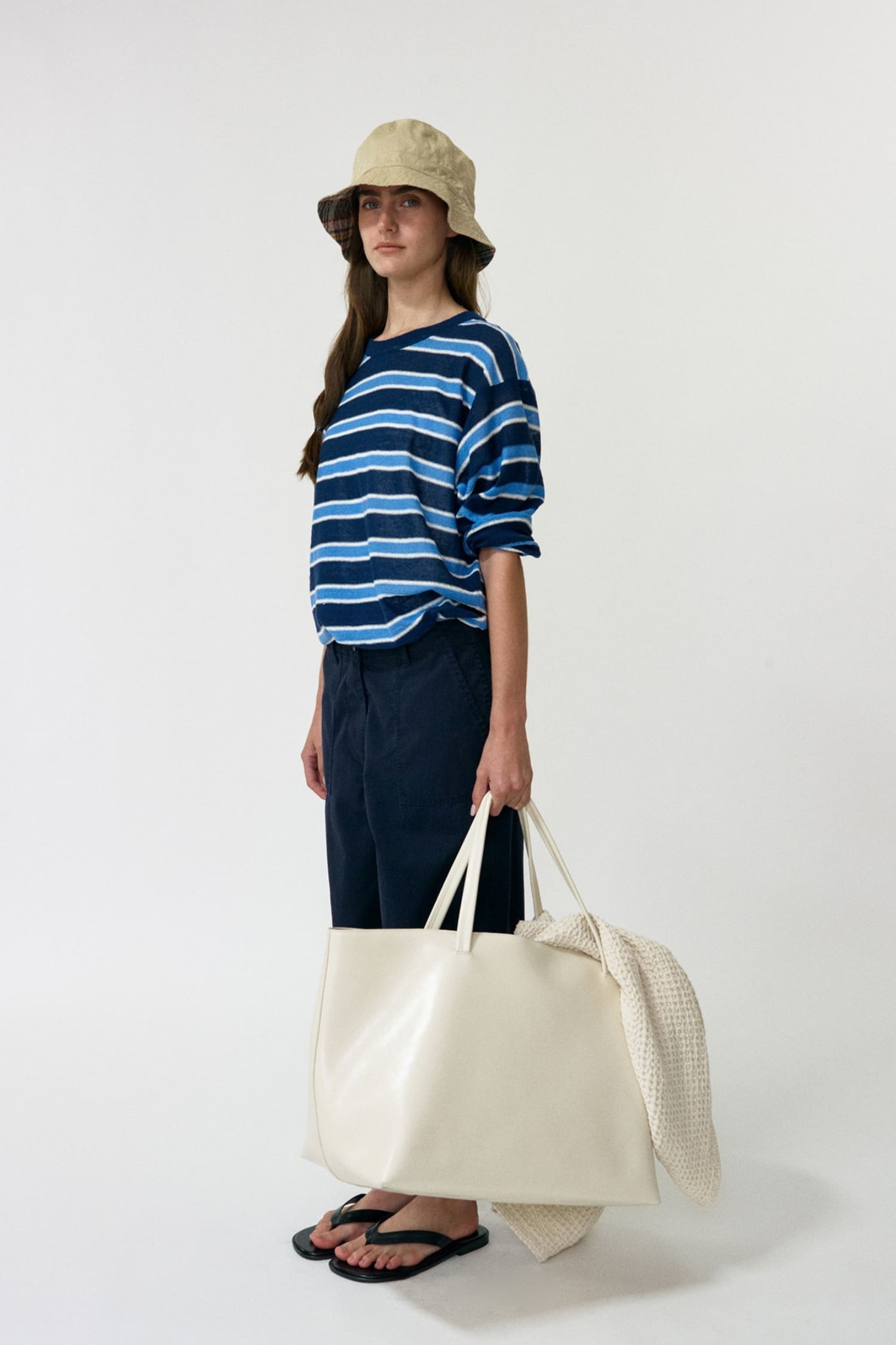 Nothing Written blue striped round pullover worn side view