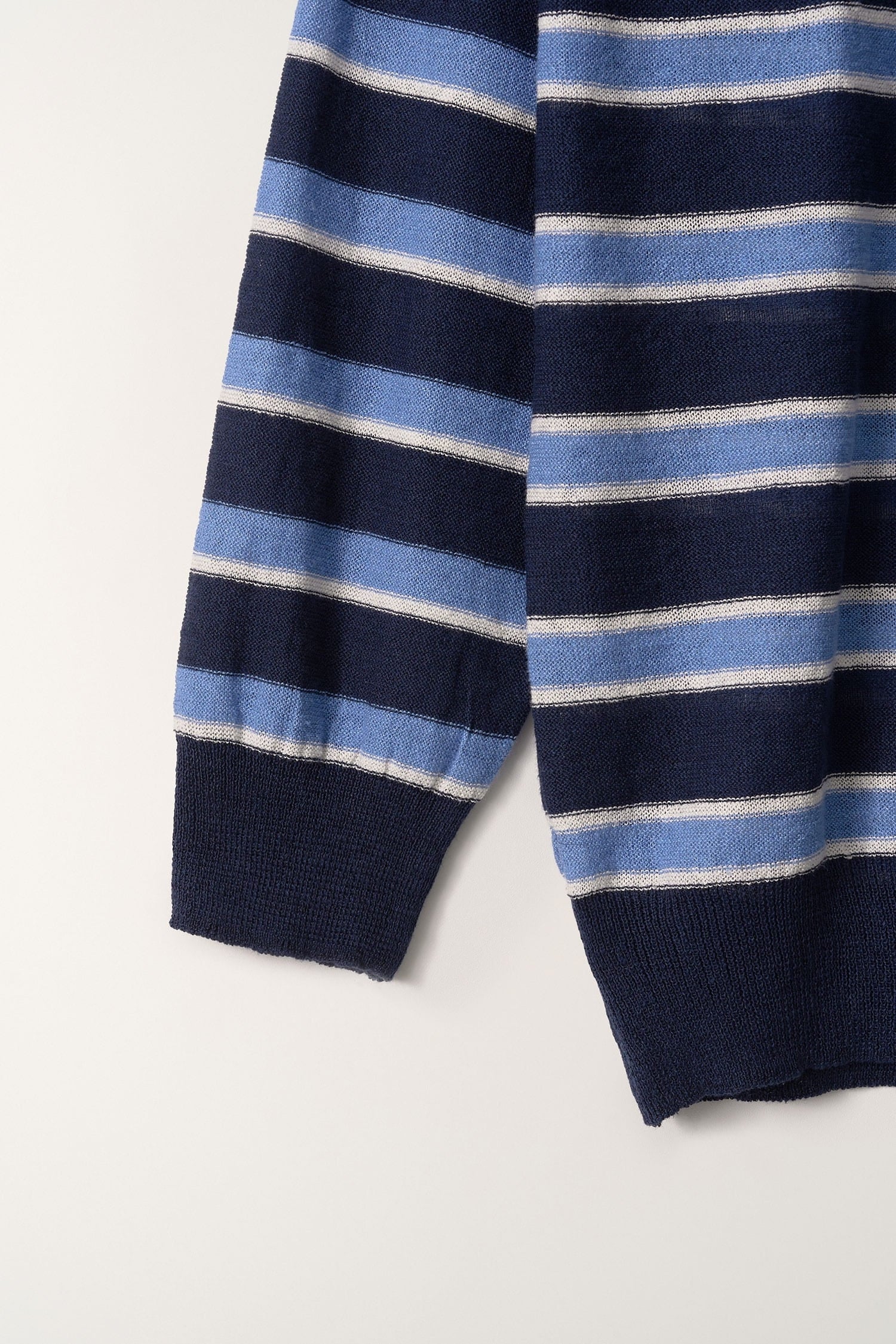 Close-up of sleeve and knit texture on Nothing Written blue striped pullover