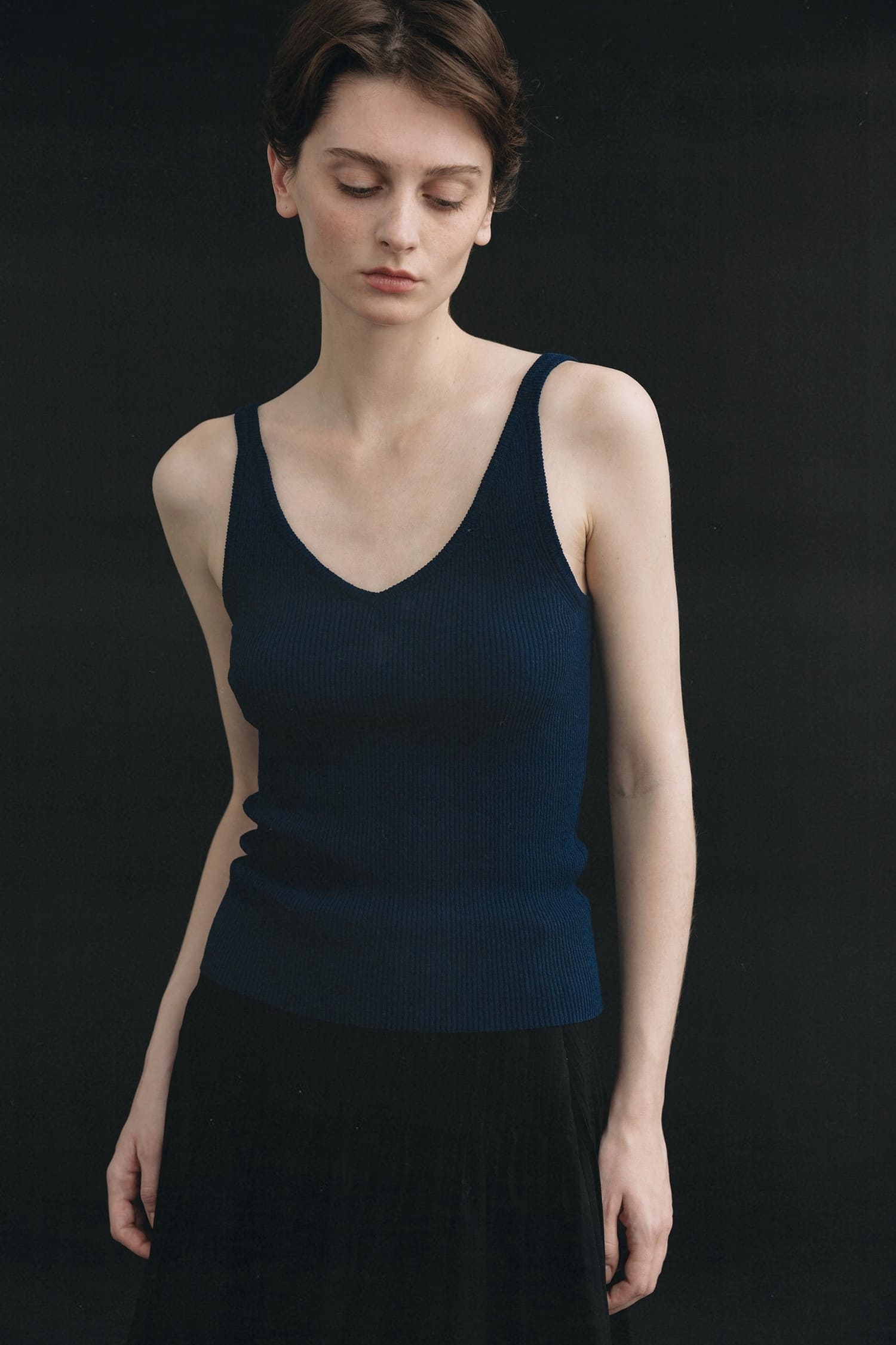 Nothing Written ribbed navy V-neck knit top worn close-up