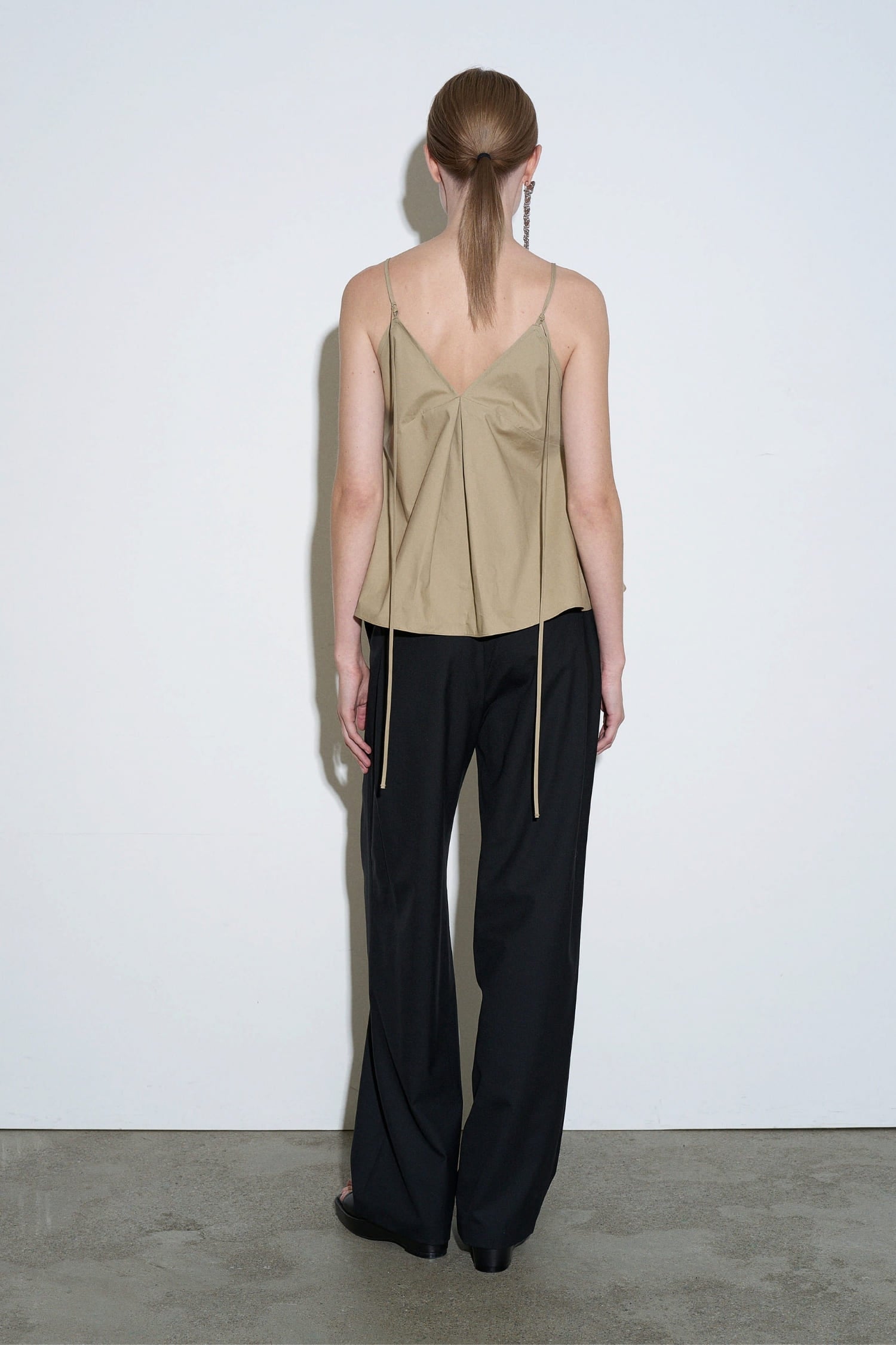 The Loom beige cotton pleated camisole back view with thin adjustable straps and soft drape