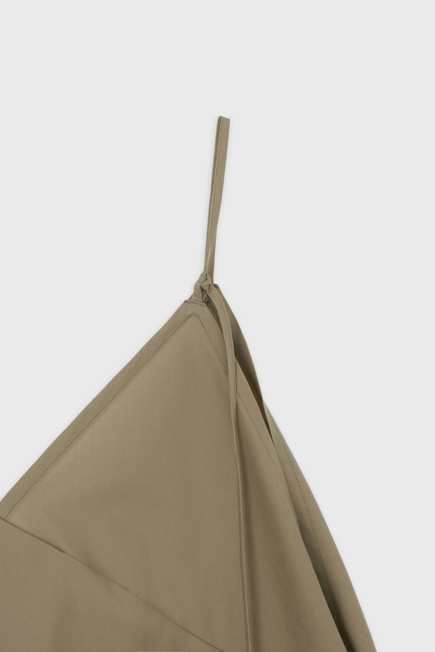 Detail of adjustable strap on The Loom beige cotton camisole