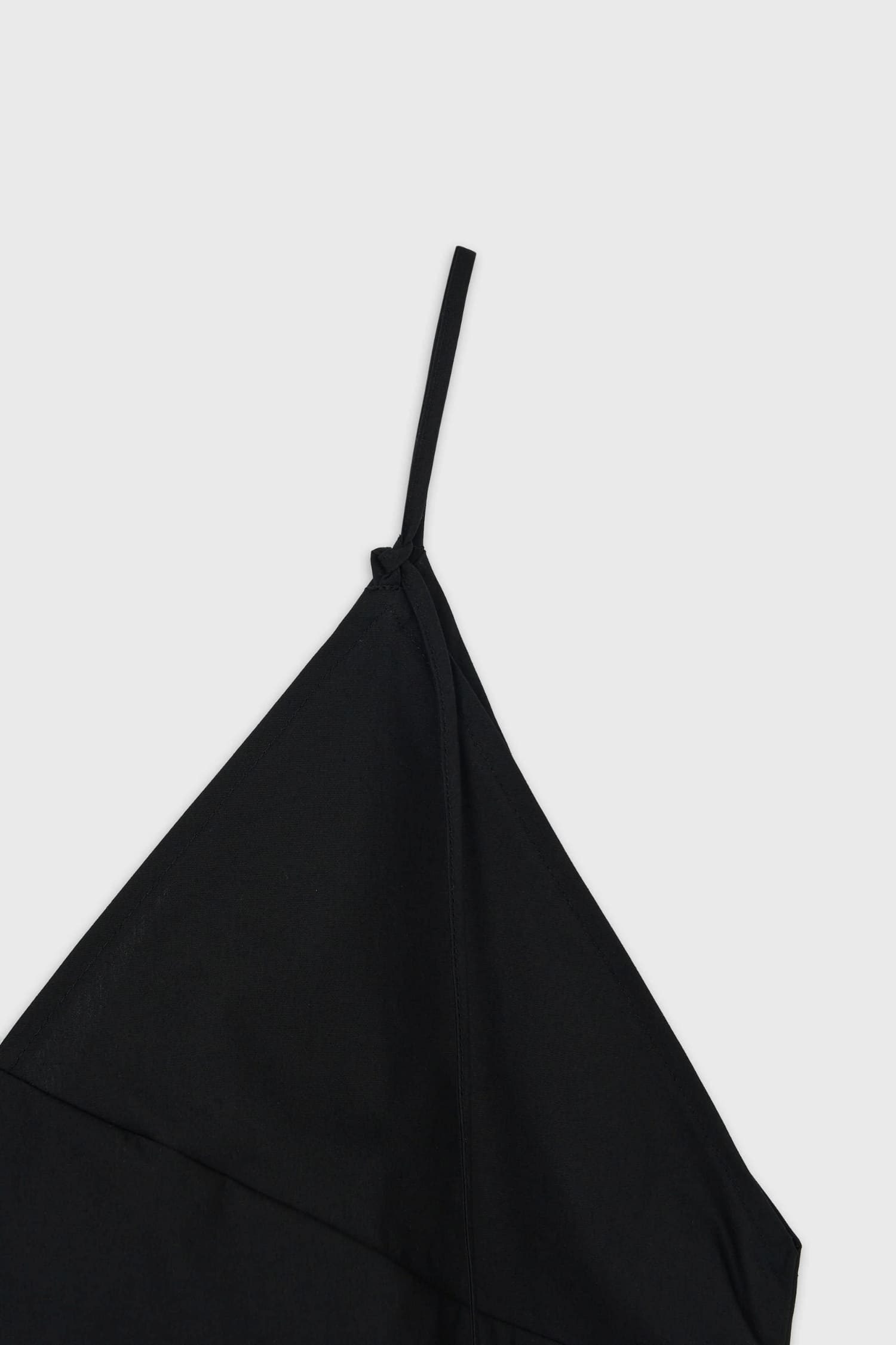Close-up of thin adjustable strap on The Loom black cotton camisole
