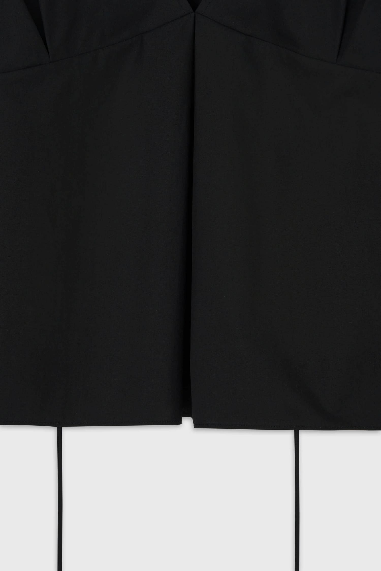 Detail of front pleated construction on The Loom black cotton V-neck camisole