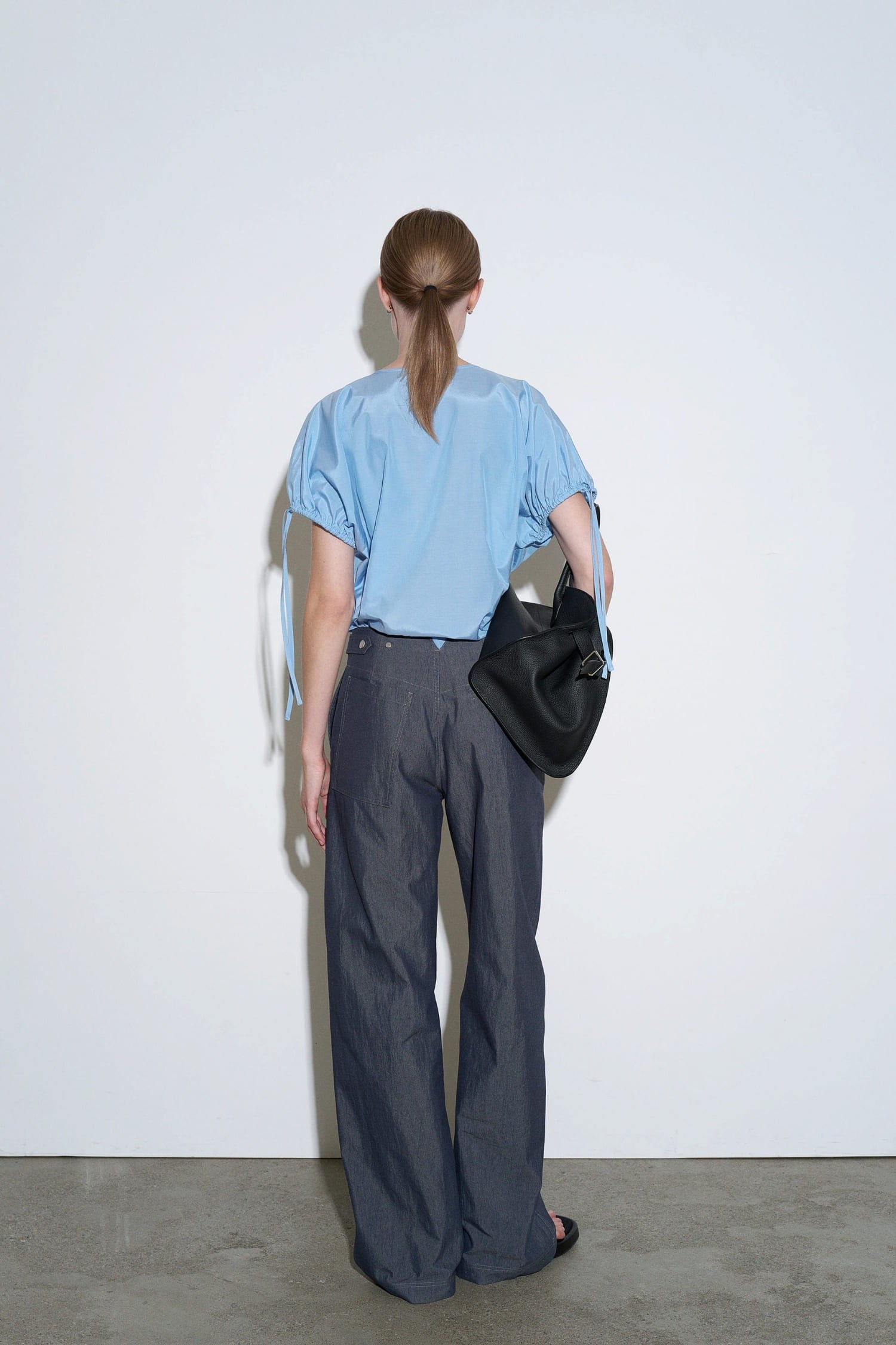 The Loom indigo denim barrel trousers back view with structured waistband and relaxed fit