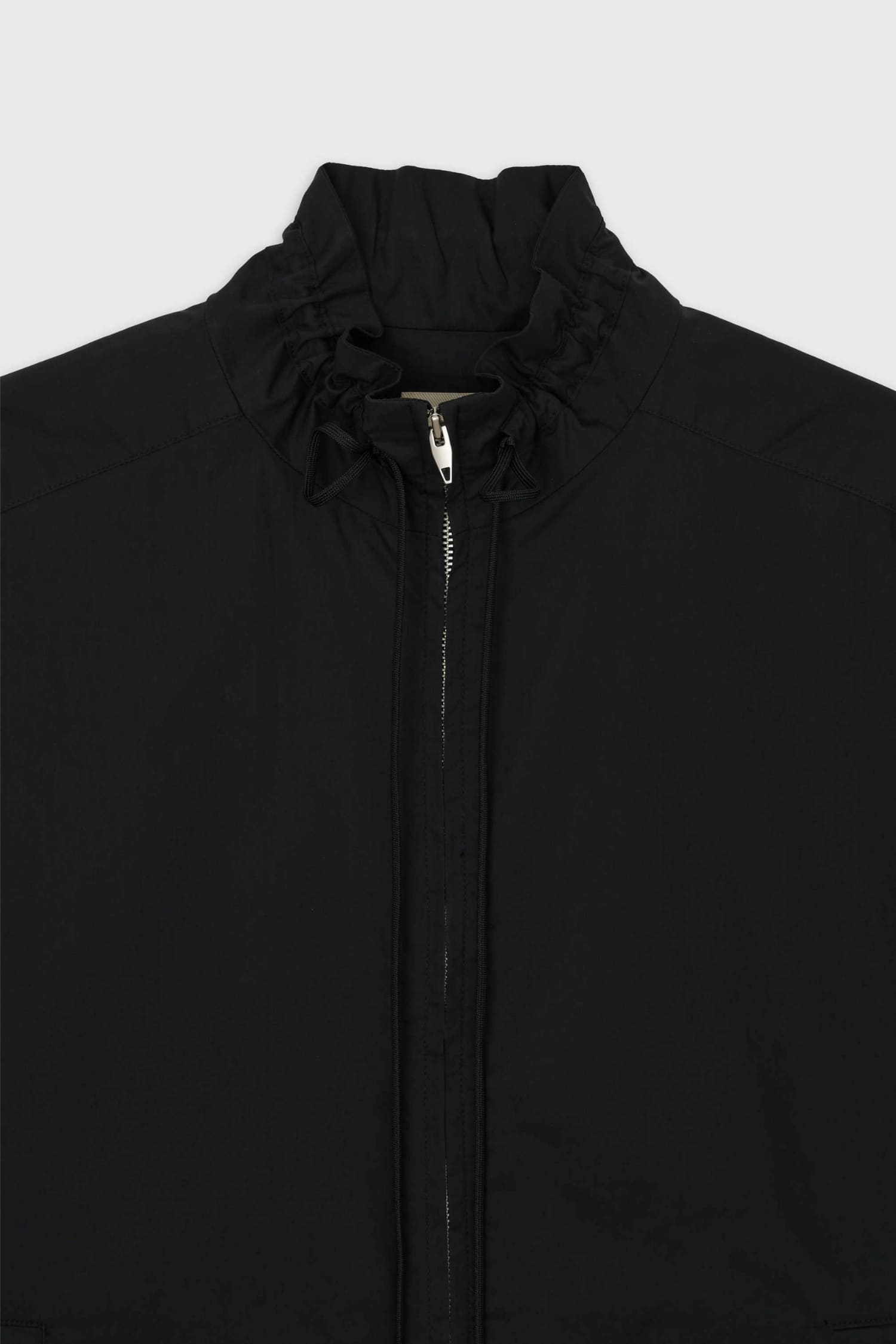 Close-up of gathered drawstring collar on The Loom black jacket