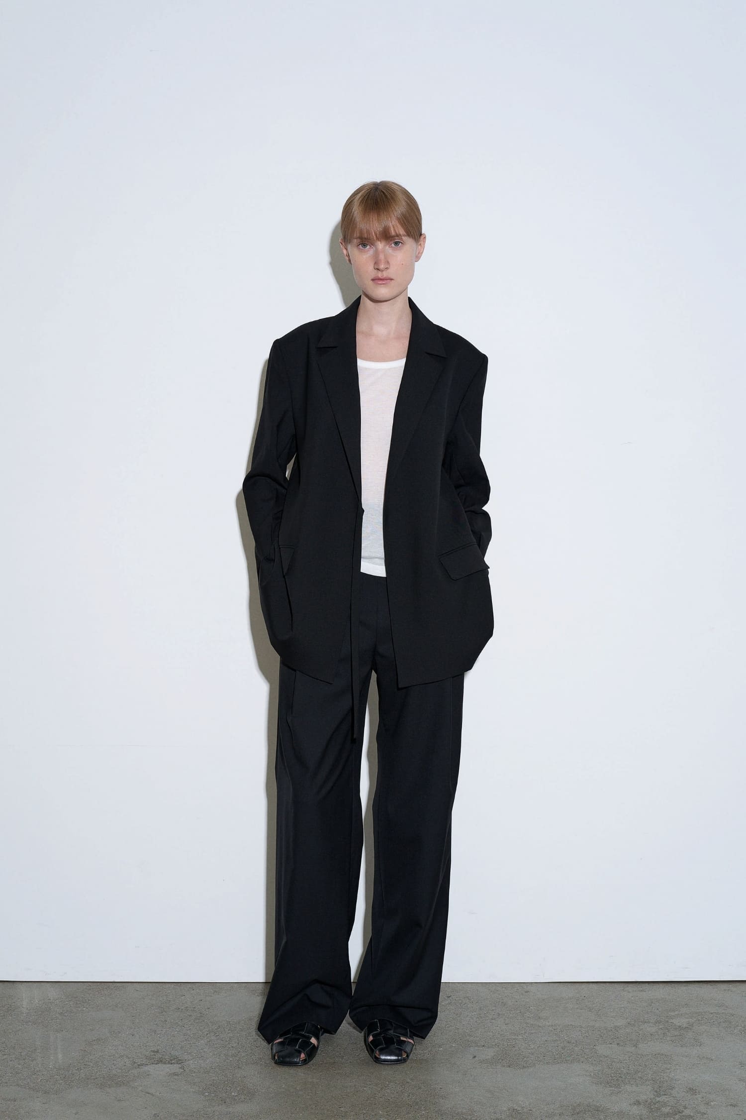  The Loom black high waisted wool trousers front view with wide straight leg silhouette | hover