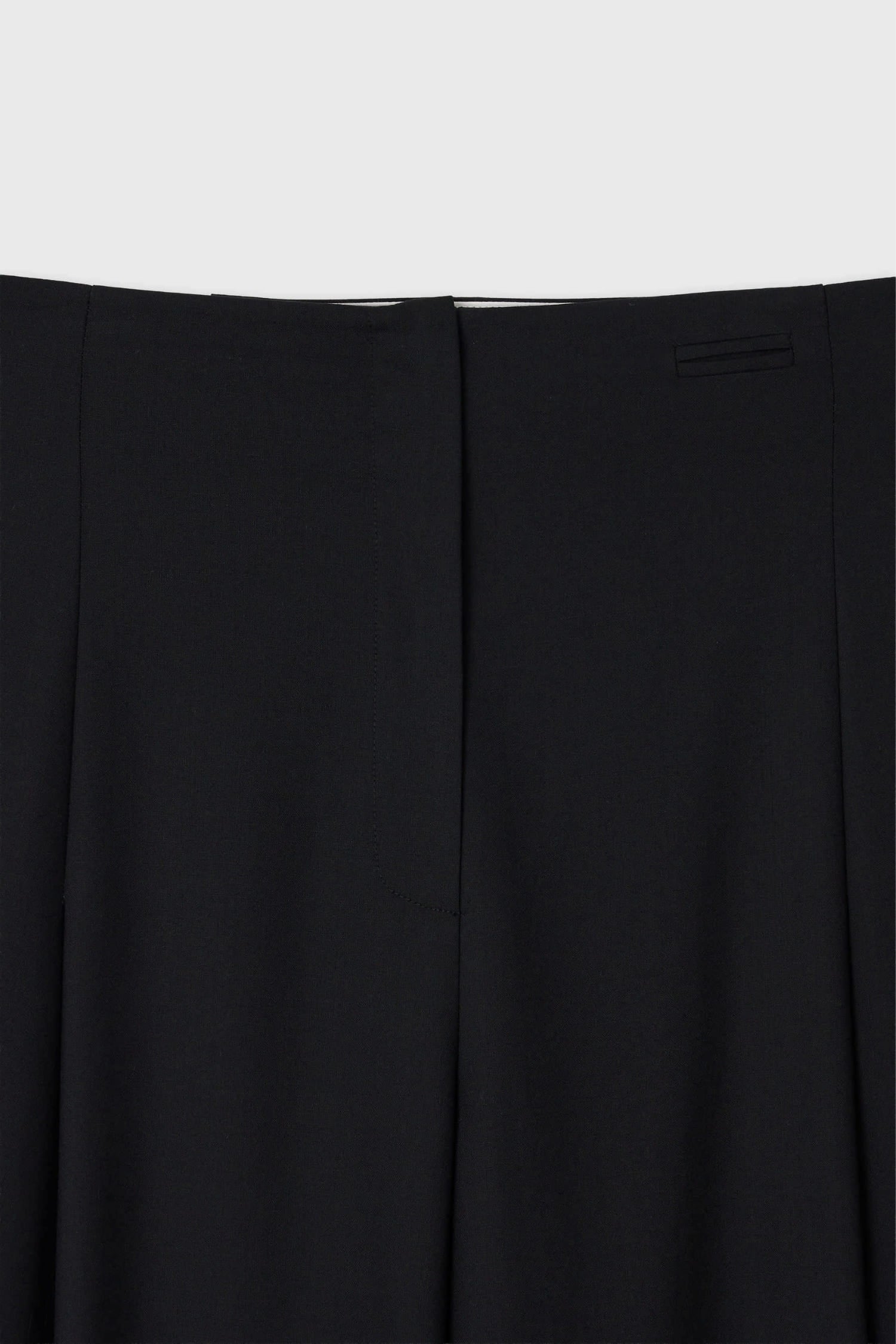 Close-up of waistband and concealed closure on The Loom black wool trousers