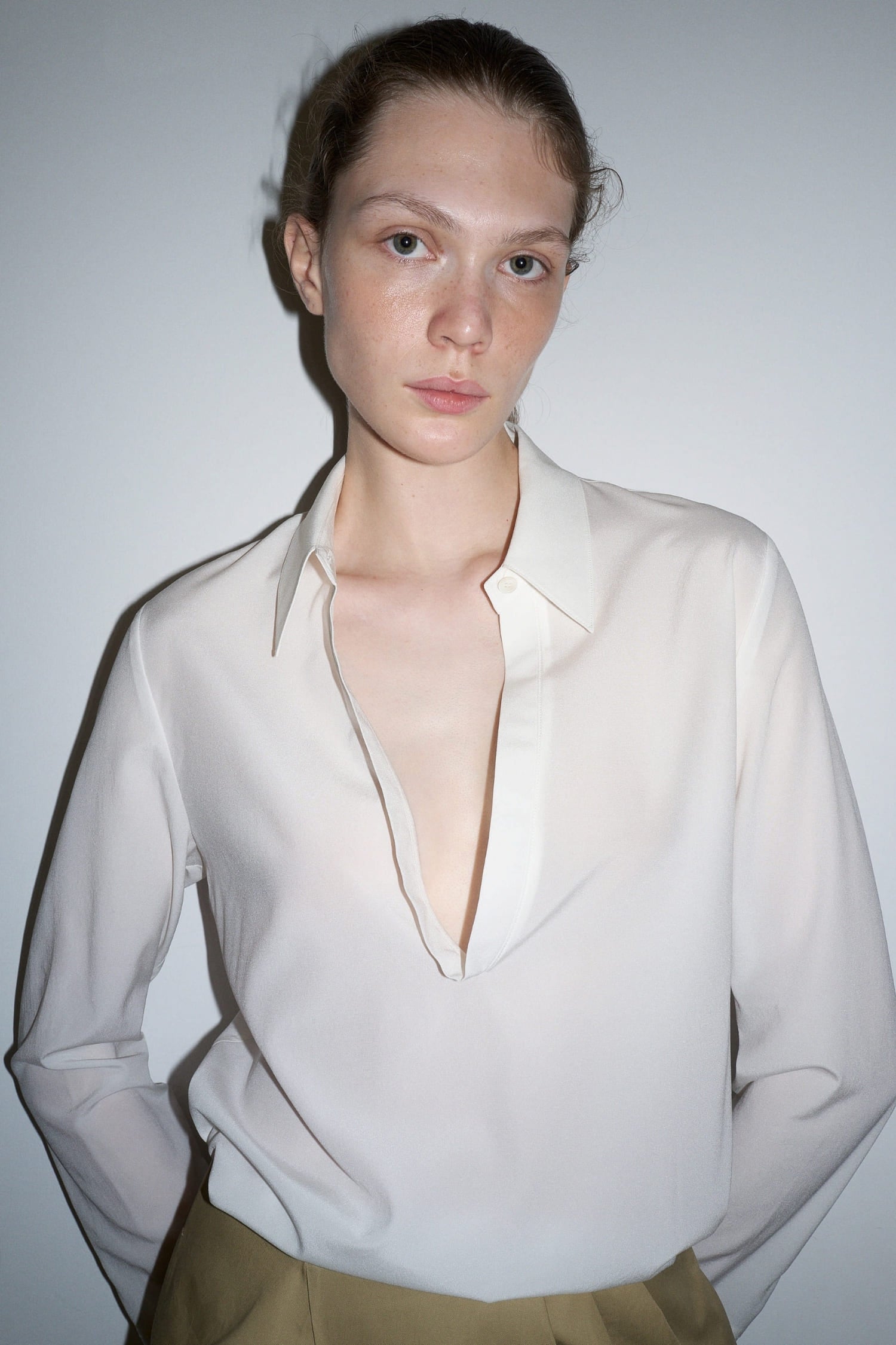 The Loom white silk open shirt deep V neckline close-up | hover