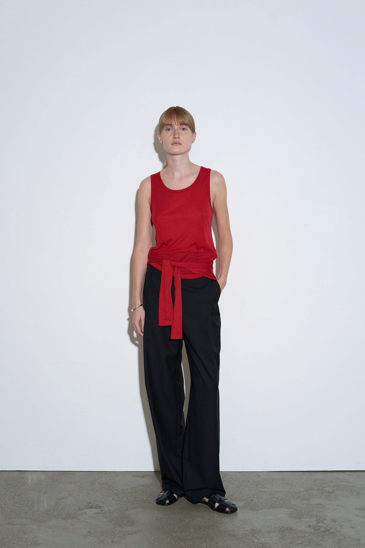 The Loom red sleeveless cotton top worn front view with relaxed fit and round neckline