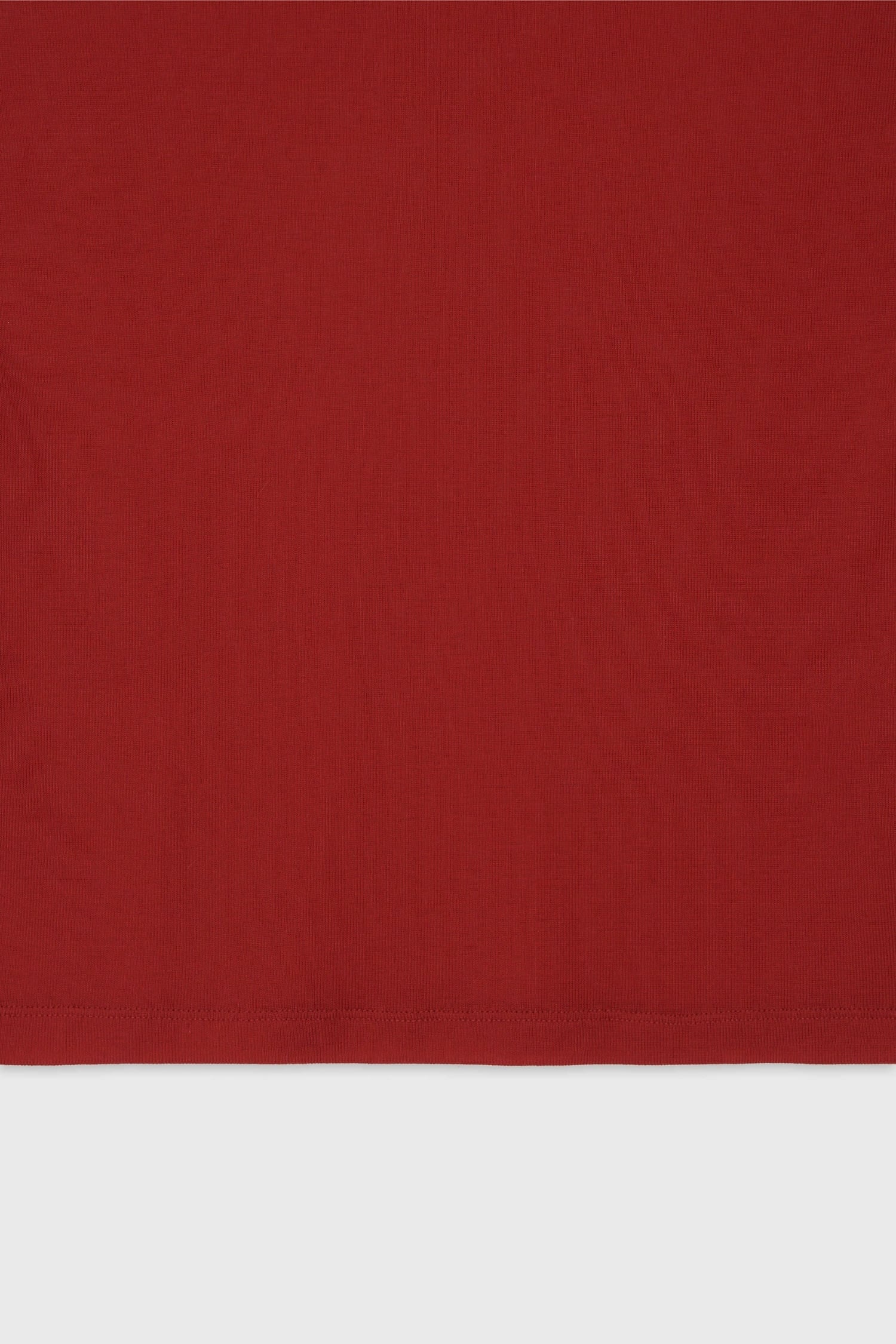 Detail of hem finish and lightweight cotton fabric on The Loom red sleeveless top