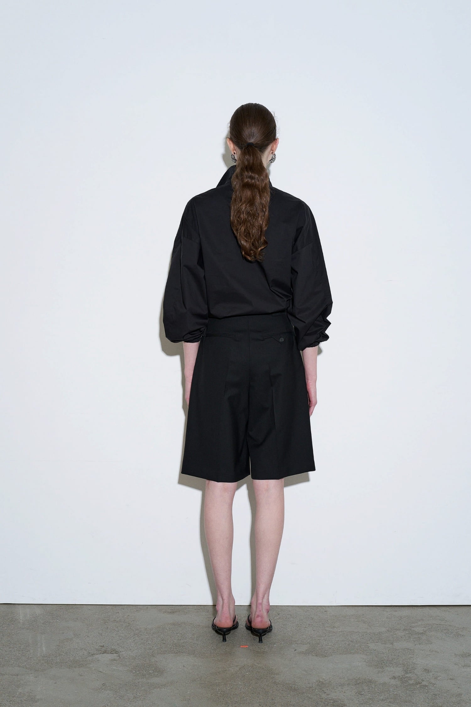 The Loom black summer wool tailored shorts back view with structured waistband and relaxed fit