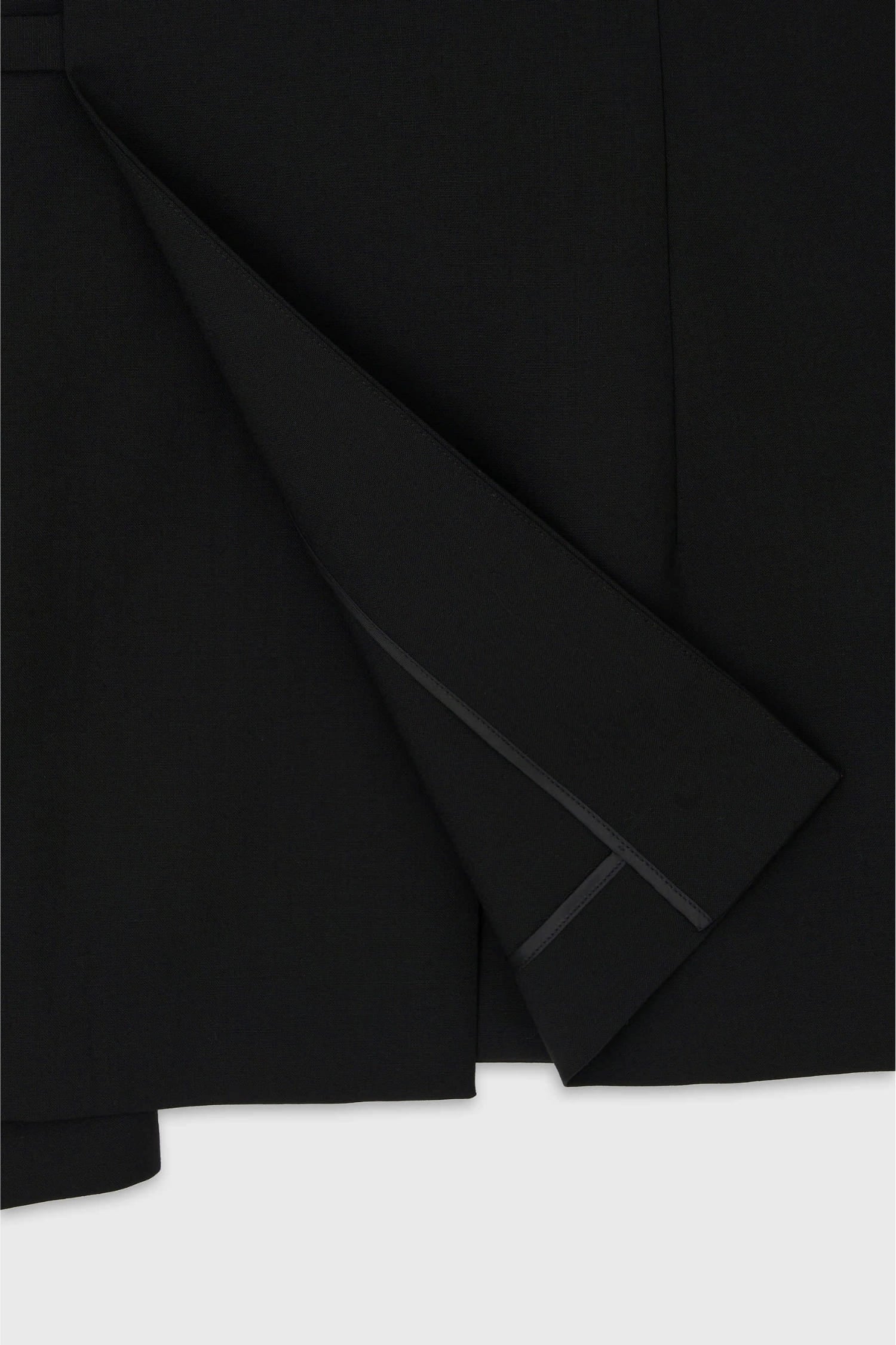 Detail of side tie fastening on The Loom black wool tailored jacket